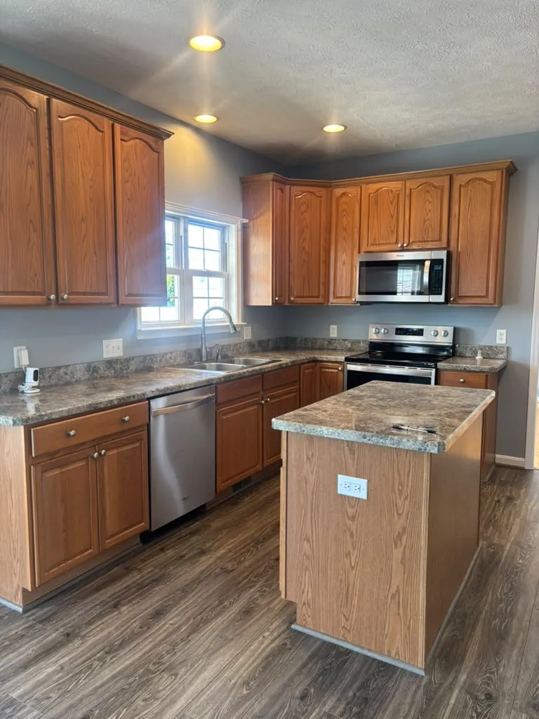 Empty kitchen with oak cabinets cleaned for a move-in