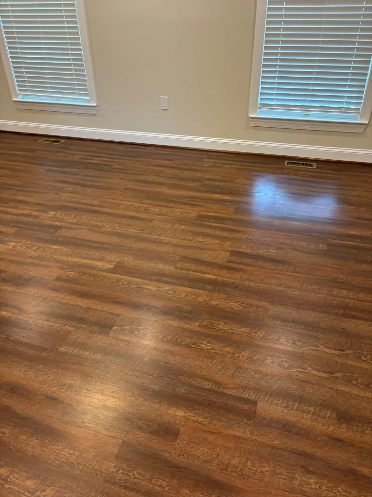 Empty room with freshly cleaned plank floors after a move-out clean