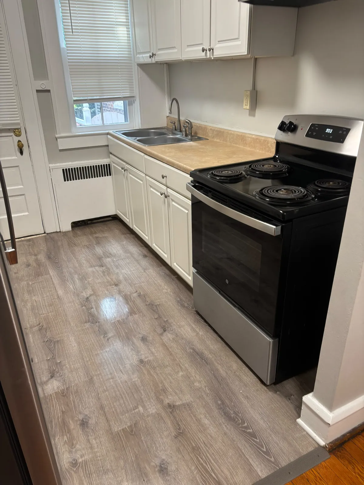 Clean kitchen with coil stove after a move-out cleaning